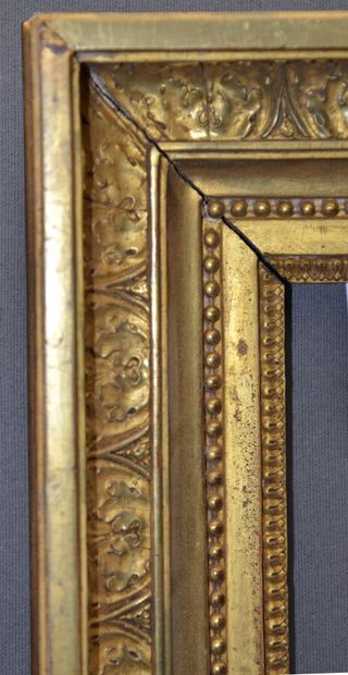 null A carved and gilded oak frame decorated with rais-de-coeur, pearl friezes and...