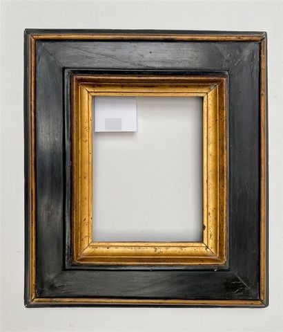 A blackened and gilded wooden frame with...