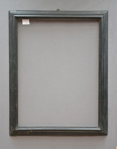 A moulded and blackened wood frame with a...