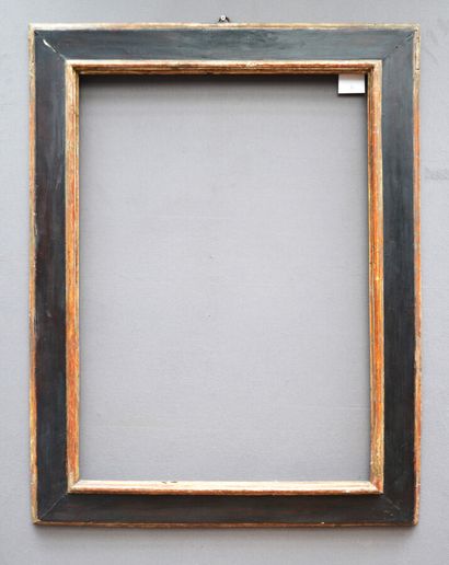 A blackened and silvered wood frame with...