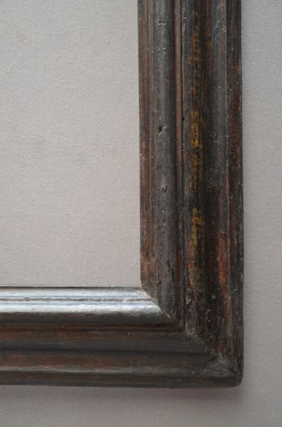 null A moulded and blackened wooden frame with a reversed profile (modified in its...