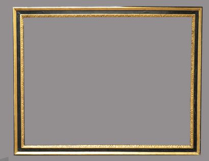 null A cassetta frame in blackened and gilded wood with a frieze of water leaves.

Italy,...