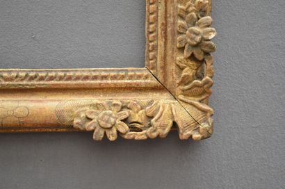 null A carved and gilded wooden frame decorated with fleur-de-lys and sunflowers...