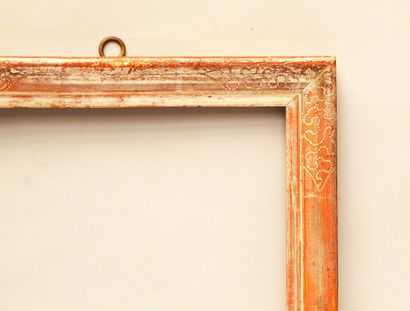 null A moulded and silvered wooden frame with a reparure decoration in the corners.

Italy,...