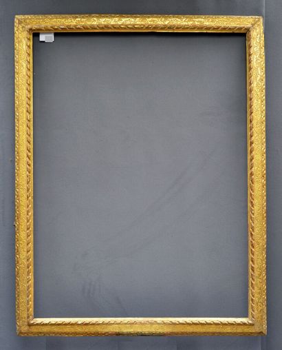 null A carved and gilded limewood frame with a twisted ribbon, foliage and flowers...