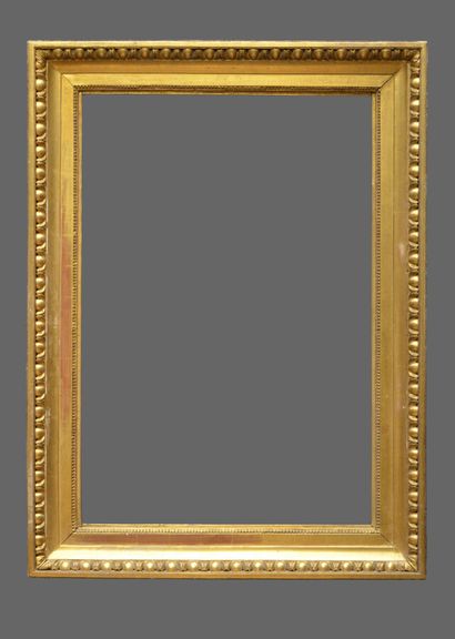 null A carved and gilded wood frame with a heart-shaped motif and a frieze of gadroons.

Italy,...