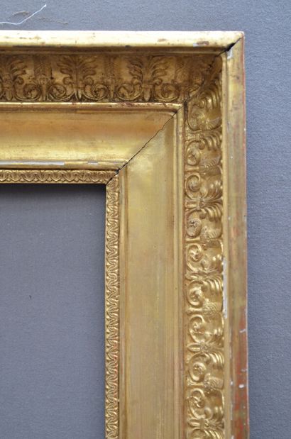 null A large gilded wood and paste frame decorated with rais-de-coeur and a frieze...