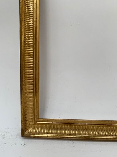 null A carved and gilded wood frame, the pediment centered with an openwork ribbon...