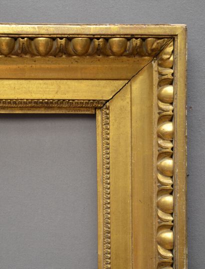 null A carved and gilded wood frame with a heart-shaped motif and a frieze of gadroons.

Italy,...