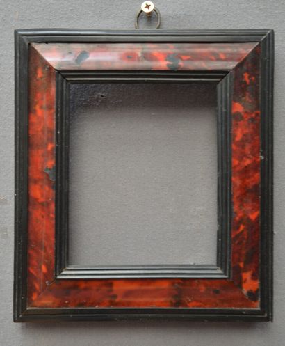 null A small tortoiseshell veneered frame with a blackened wood edge and rebate

Italy,...