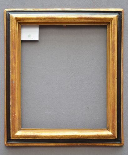 A moulded, gilded and blackened wood frame...
