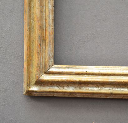 null A moulded and silvered wooden frame with foliage decoration in the corners (small...