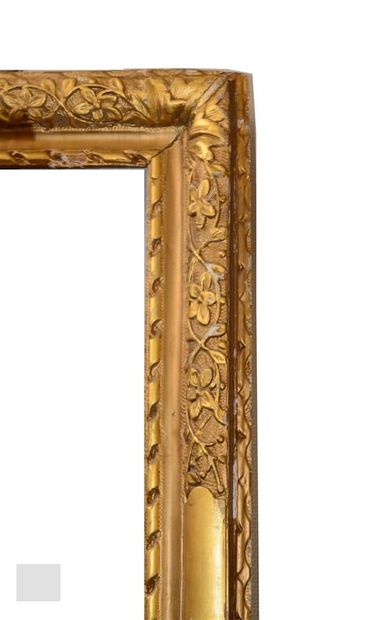 null A carved and gilded wooden frame decorated with friezes of flowery elements...