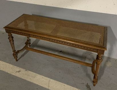 null Molded and carved wood piano bench, the seat caned, resting on tapered and fluted...