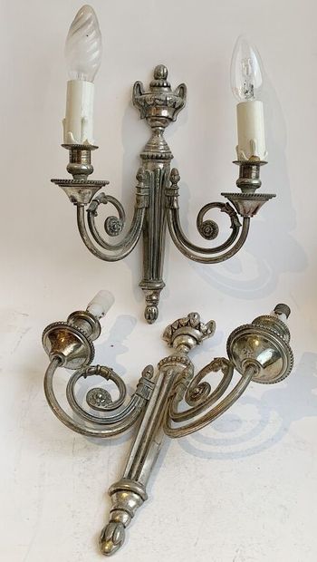 null Pair of sconces in silvered bronze with two arms of light, the shaft simulating...