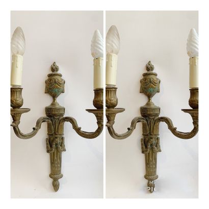 null Pair of sconces in varnished bronze with two arms of light, the shaft simulating...