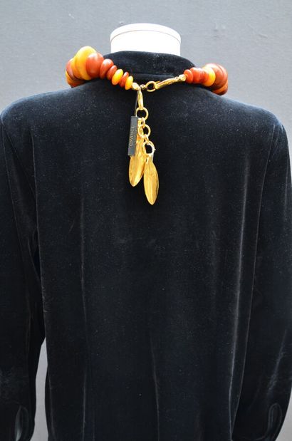 null CHANEL - Necklace in amber-colored resin, gilded bronze clasp holding charms...