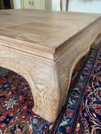 null Coffee table in ceruse oak, the belt scalloped, resting on four curved legs....
