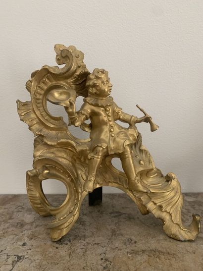 null Pair of gilt bronze andirons featuring a couple of musicians sitting on rocaille....