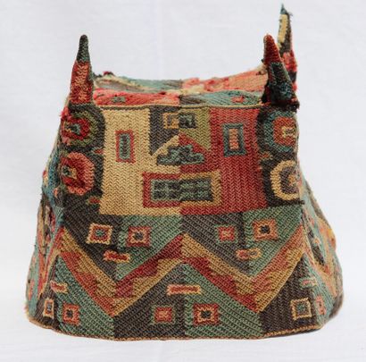 null Ceremonial hat "with four points 

Its rich decoration is organized in two registers....