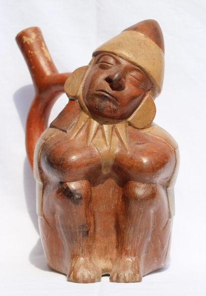 null Stirrup-handled vase representing a sleeping dignitary. 
Seated with his legs...