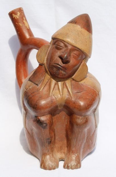 null Stirrup-handled vase representing a sleeping dignitary. 
Seated with his legs...