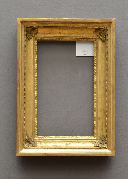 null Wooden frame and gilded paste, decorated with frieze of water leaf, pearls and...