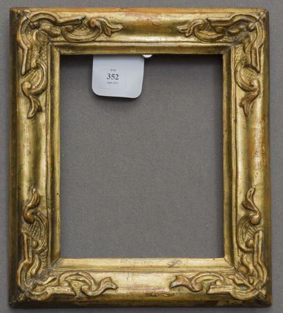 null A molded, carved and gilded wooden frame decorated with rocaille style clasps...