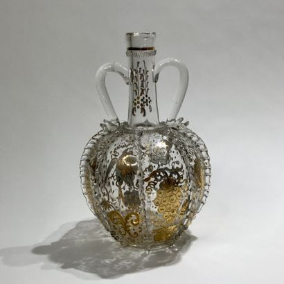 null Ovoid carafe out of blown glass with two handles, the body with twisted ribs...