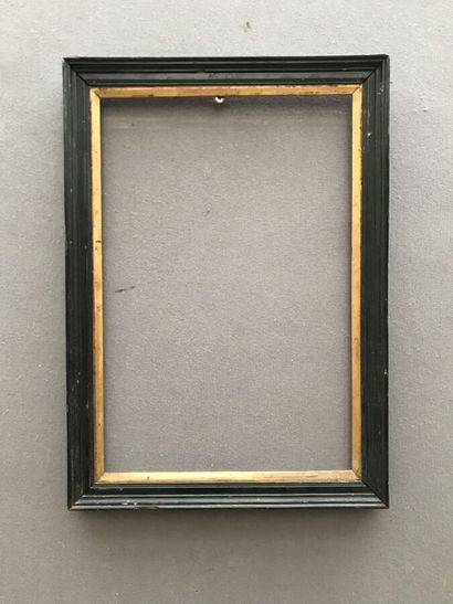 Frame in blackened molded wood with gilded...