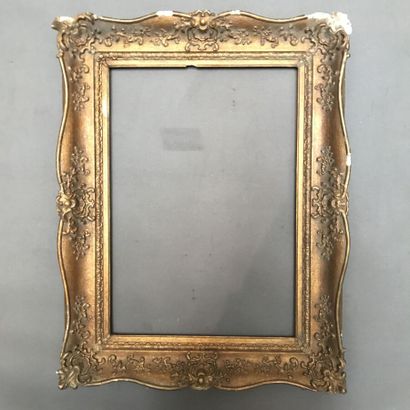 null Carved and gilded wood frame decorated with a frieze of foliage and shells....