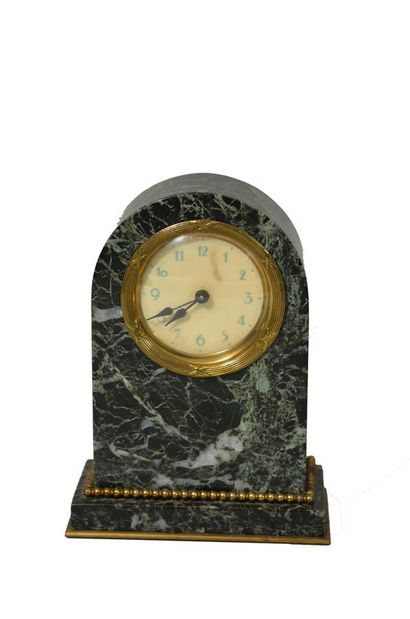 null PENDULETTE 
green marble and gilt bronze clock decorated with a frieze of pearls,...