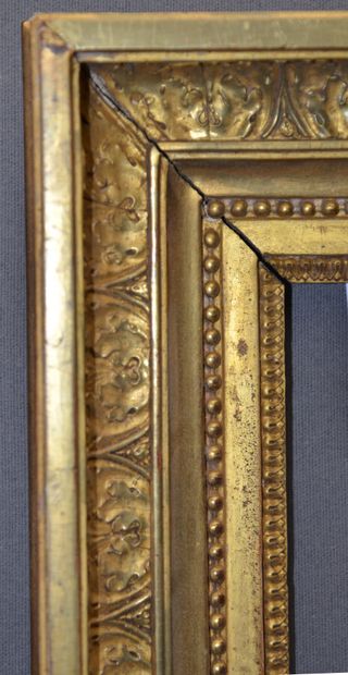 null Carved and gilded oak frame decorated with rais-de-coeur, pearl friezes and...