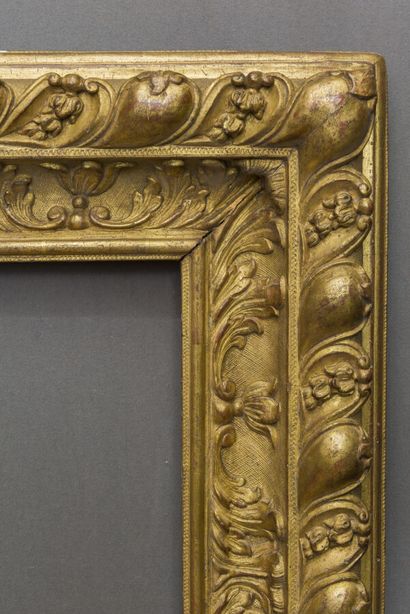 null Large FRAME 
in molded, carved and gilded oak, decorated with a frieze of acanthus...