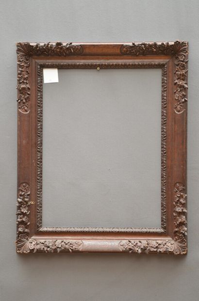 null Frame in natural oak carved and waxed, decorated with a frieze of acanthus leaves,...