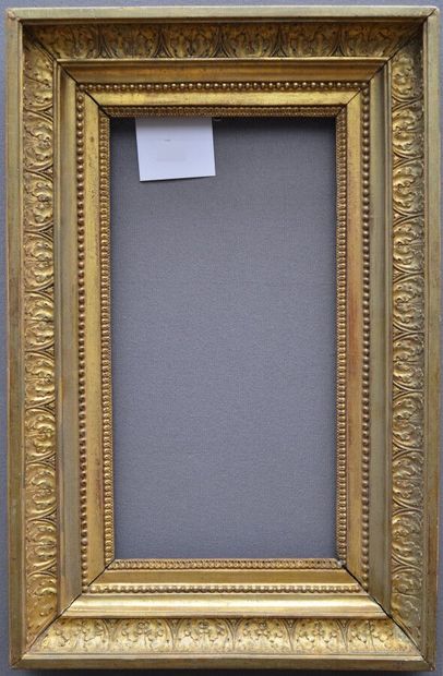 null Carved and gilded oak frame decorated with rais-de-coeur, pearl friezes and...