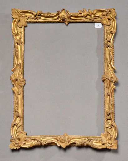 null Gilded wood frame richly carved with asymmetrical foliage scrolls with median...