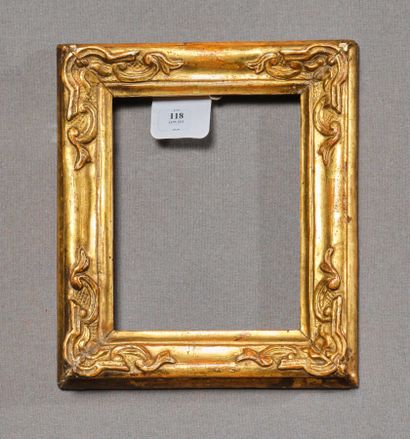 null Frame in molded wood, carved and gilded with rocaille style staples in the corners....