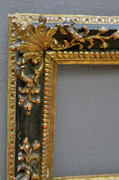 null Oak frame, molded carved, blackened and gilded, decorated with watered gadroons...