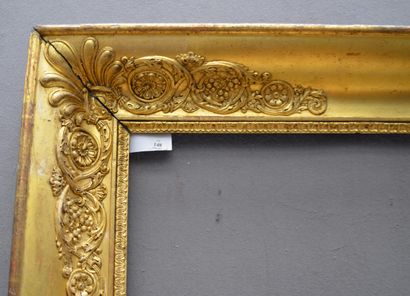 null Wooden frame, gilded paste, with decoration of plumes, scrolls and vine leaves...