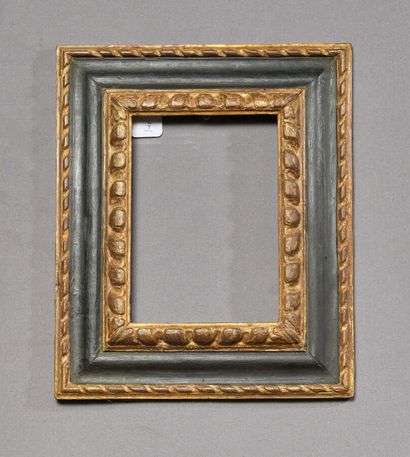 null Frame with reversed profile in molded, carved and blackened wood decorated with...