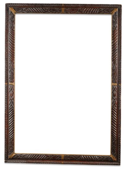 FRAME 
in wood carved with scrolls and laurel...