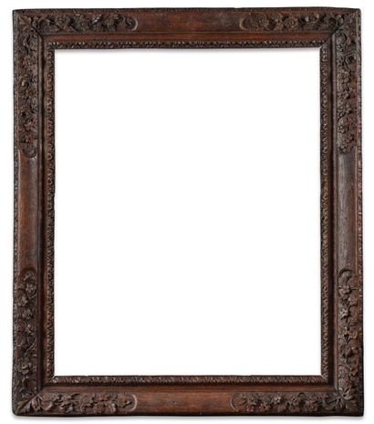 FRAME 
in natural molded oak carved with...