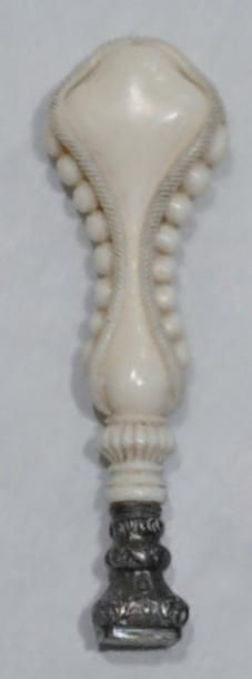 null Un CACHET en ivoire sculpté d'un décor de cordages et de perles. Milieu XIXème...