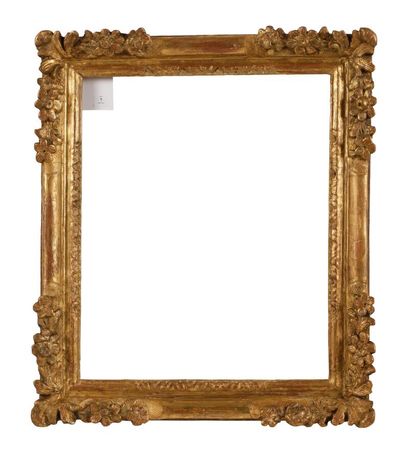 A molded, carved and gilded wooden frame...