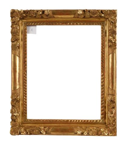A molded, carved and gilded wooden frame...