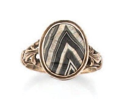 null BAGUE en or jaune centrée d'une agate rubanée en chevrons, gravée d'un profil...