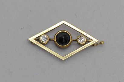 null BROCHE losangique en alliage d'or jaune centrée d'un saphir cabochon et bordée...