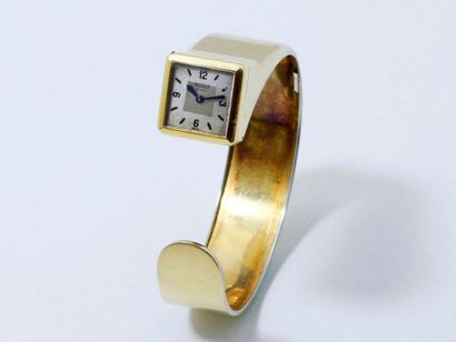 null Bracelet rigide ouvert en or 750 millièmes, garni d'une montre, le cadran argenté...