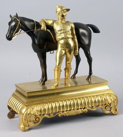 null CHEVAL ET SON JOCKEY. Épreuve en bronze à patine brun nuancé et doré. Travail...